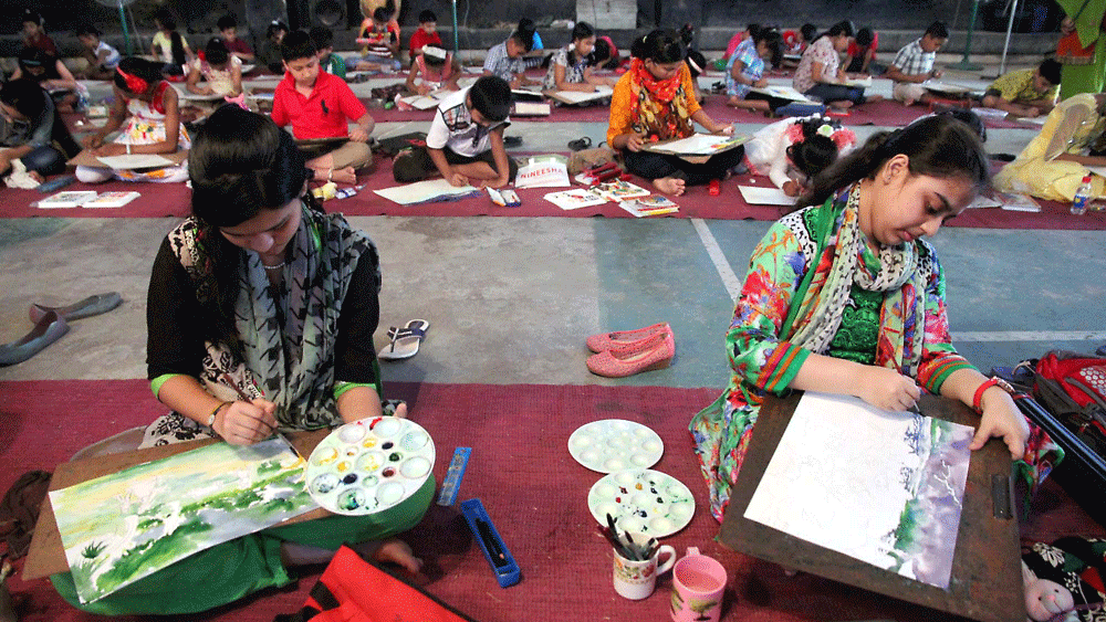 Children participating at  the art competition organised by the Sylhet city corporation to mark the Bengali new year 1422 at Mohammad Ali Gymnasium at Rikabi Bazar of the city on Monday. Photo: Anis Mahmud, Sylhet