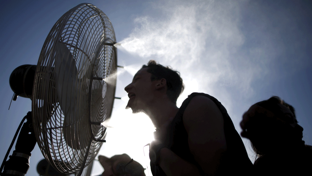 People cool off in misters at the Coachella Valley Music and Arts Festival in Indio, California April 12, 2015. Photo:  Reuters