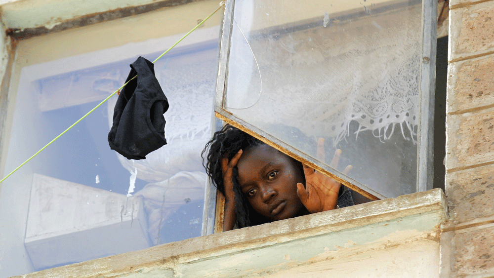 A student at the University of Nairobi looks down from the window at the Kimberly ladies hostels at the Kikuyu campus near the capital Nairobi, April 12, 2015. A Kenyan student died and more than 100 others were injured as they fled after a electricity transformer explosion before dawn on Sunday triggered fears that their campus was being attacked, officials said. Photo: Reuters