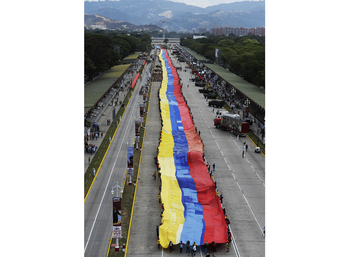 Members of the Bolivarian militia deploy a 1200-metre-long Venezuelan flag in Caracas on April 13, 2015 during a rally in protest against US sanctions against Venezuelan officials. Photo:  AFP