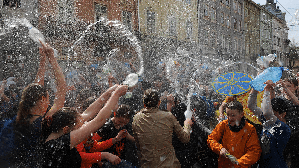 People spray water on one another in the western Ukrainian city of Lviv on April 13, 2015, as they celebrate Clean Monday (or Wet Monday), a Ukrainian Christian tradition celebrated on the first day after Orthodox Easter. Photo: AFP