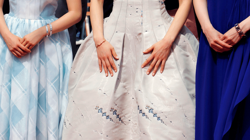 The dresses and the hands of cast members (L-R) Suzu Hirose, Haruka Ayase and Kaho are pictured as they pose on the red carpet for the screening of the film "Our Little Sister" (aka Umimachi Diary). Photo: Reuters