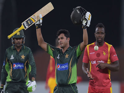 Pakistan's captain Azhar Ali (C) celebrates after scoring a century (100 runs) as teammate Haris Sohail (L) and Zimbabwe bowler Brian Vitori (R) look on during the second ODI between Pakistan and Zimbabwe. Photo: AFP