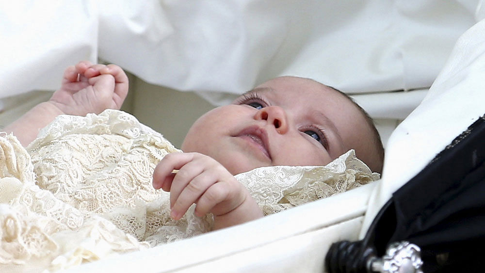 Princess Charlotte is seen inside a pram as she leaves the Church of St. Mary Magdalene in Sandringham, Britain after her christening July 5, 2015. Photo: Reuters