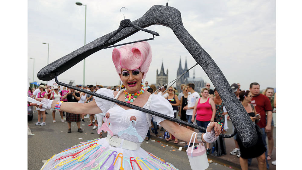 A reveller takes part in the annual Christopher Street Day gay parade (CSD) with a huge home-made coat-hanger costume in front of the Cologne cathedral, western Germany, July 5, 2015. Photo: Reuters