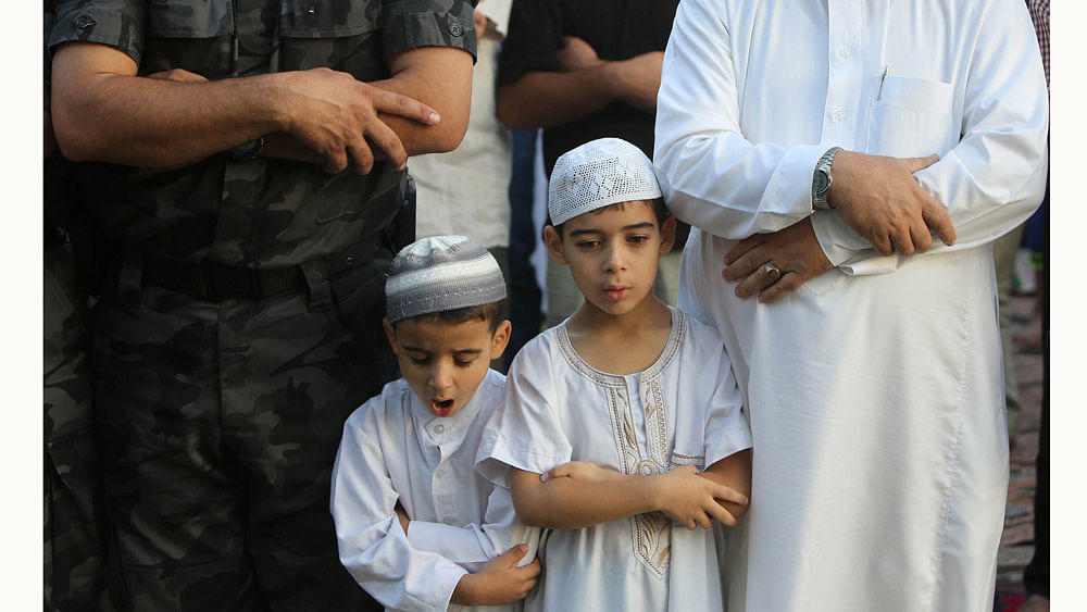 Palestinian Muslim boys attend the Eid al-Fitr prayer early on July 17, 2015. Photo: AFP