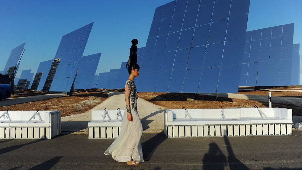 Catwalk producer and model Jessica Minh Anh presents a creation by Hoang Hai during the Jessica Minh Anh’s Summer Fashion Show 2015 at Gemasolar, a solar power plant in Fuentes de Andalucia, in the province of Sevilla on July 17, 2015. Photo: Photo: AFP