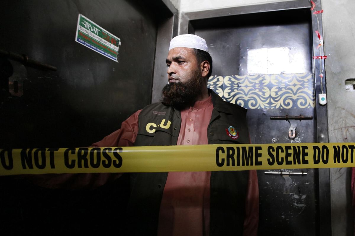 A policeman stand guards outside the home of murdered Bangladeshi blogger Niloy Chakrabarti, who used the pen-name Niloy Neel, in Dhaka on August 7, 2015.