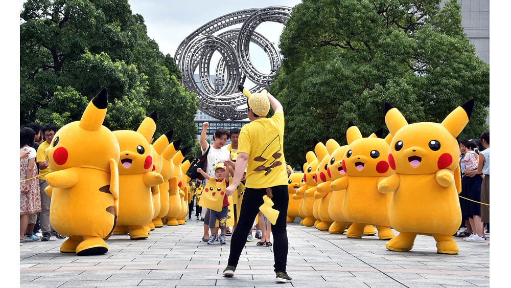 Dozens of Pikachu characters march at the Landmark Plaza shopping mall in Yokohama, suburban Tokyo on August 13, 2015.