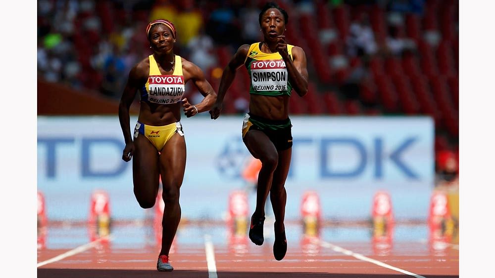 Sherone Simpson of Jamaica (R) and Narcisa Landazuri of Ecuador compete in the women
