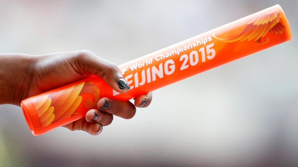 Sherone Simpson of Jamaica holds the baton during during her women