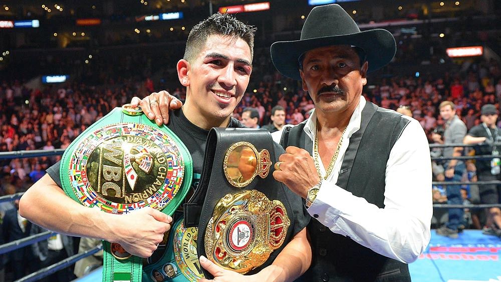 Leo Santa Cruz and his father Jose Santa Cruz in the ring after he defeated Abner Mares (not pictured) in their WBC Diamond and WBA Featherweight Championship. Photo: Reuters