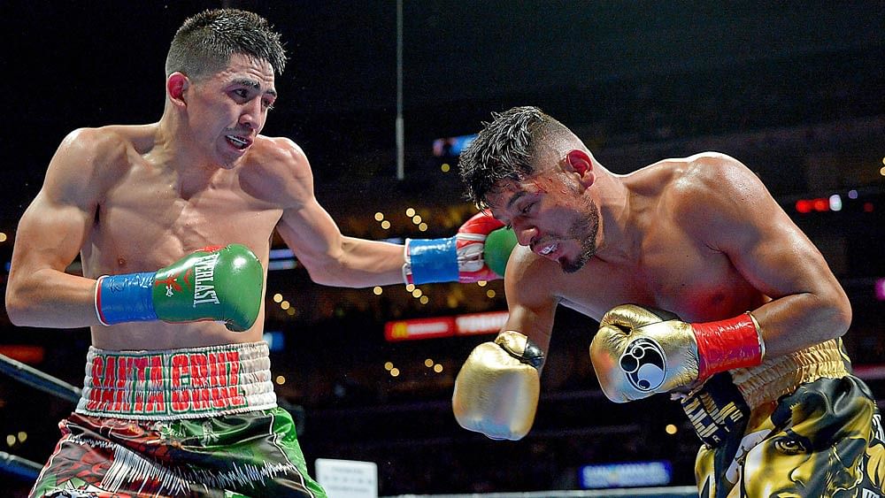 Leo Santa Cruz (green gloves/blue tape) and Albert Mare (gold gloves/red tape) in their WBC Diamond and WBA Featherweight Championship. Photo: Reuters