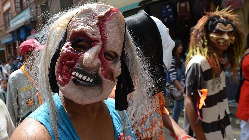 A Nepalese Buddhist devotee wears a mask as he participates in the Neku Jatra-Mataya festival in Patan, on the outskirts of Kathmandu on August 31, 2015. Photo: AFP