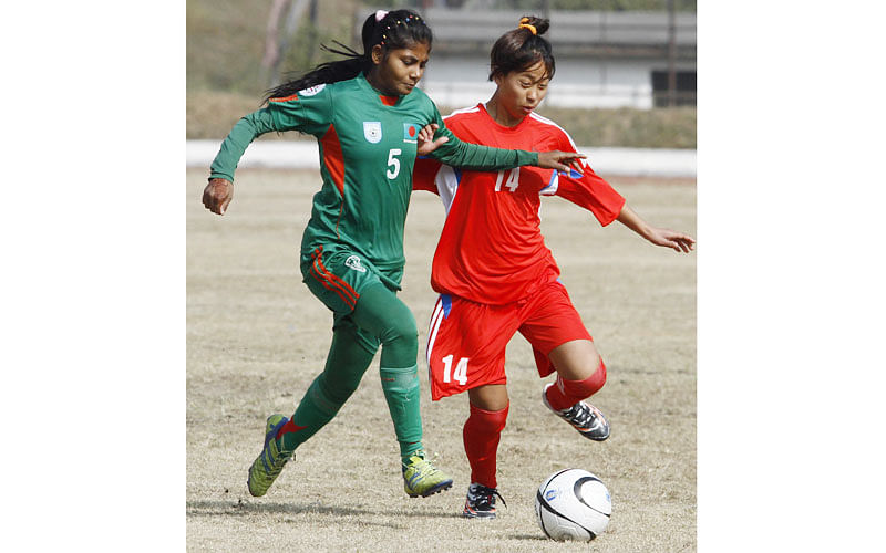 5.	Nepalese U-14 girls football player Manjali Kumari (R) and Bangladesh`s Nargis Khatun (L) tussle for the ball during the AFC regional championship match in Kathmandu on December 20, 2015. Bangladesh won 1-0. AFP