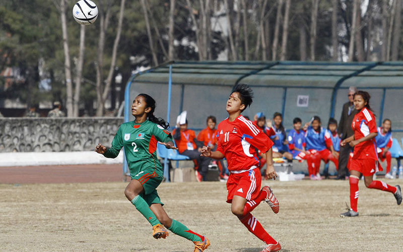 4.	U-14 girls football players Nirmala Updhaya (R) and Bangladesh`s Shamsunnahar (L) play during the AFC regional championship match in Kathmandu on December 20, 2015. Bangladesh won 1-0. AFP