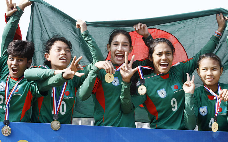 1.	Bangladeshi U-14 girls football players celebrates after winning the AFC regional championship against Nepal during the AFC regional championship match in Kathmandu on December 20, 2015. Bangladesh won 1-0. AFP