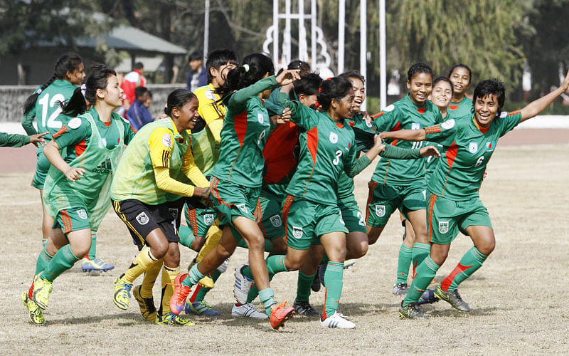 6.	Bangladeshi U-14 girls football players celebrates after winning the AFC regional championship against Nepal during the AFC regional championship match in Kathmandu on December 20, 2015. Bangladesh won 1-0. AFP