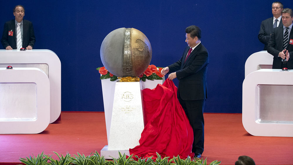 Chinese President Xi Jinping applauds after unveiling a sculpture during the opening ceremony of the Asian Infrastructure Investment Bank (AIIB) in Beijing, China, January 16, 2016. Reuters