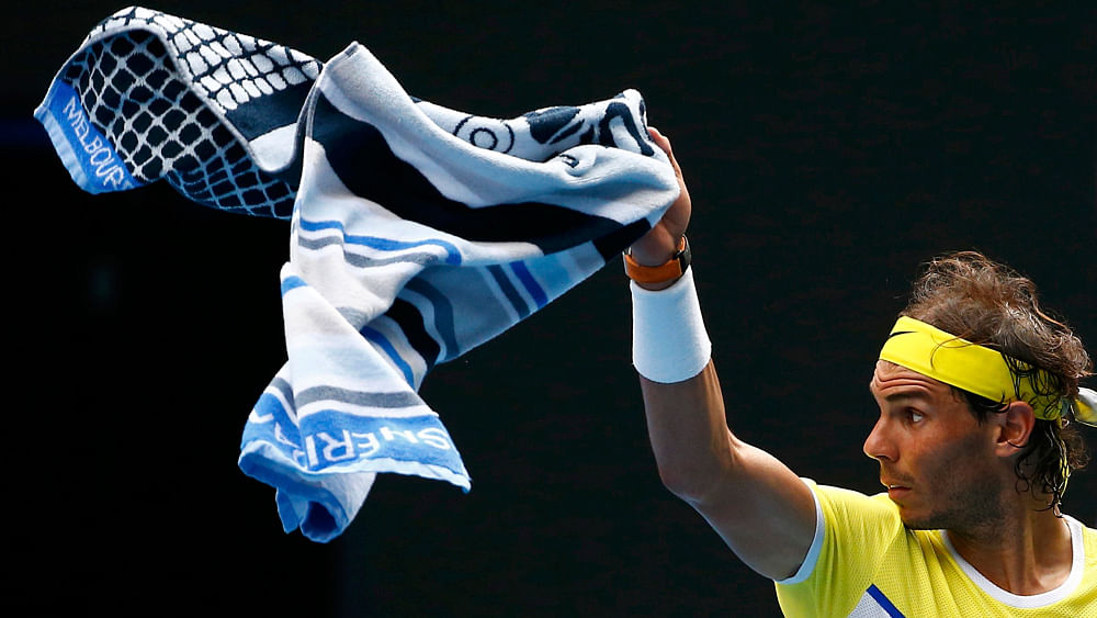 Spain`s Rafael Nadal signals a ball boy to bring his other towel during his first round match against Spain`s Fernando Verdasco at the Australian Open tennis tournament at Melbourne Park, Australia, January 19, 2016. Photo: Reuters