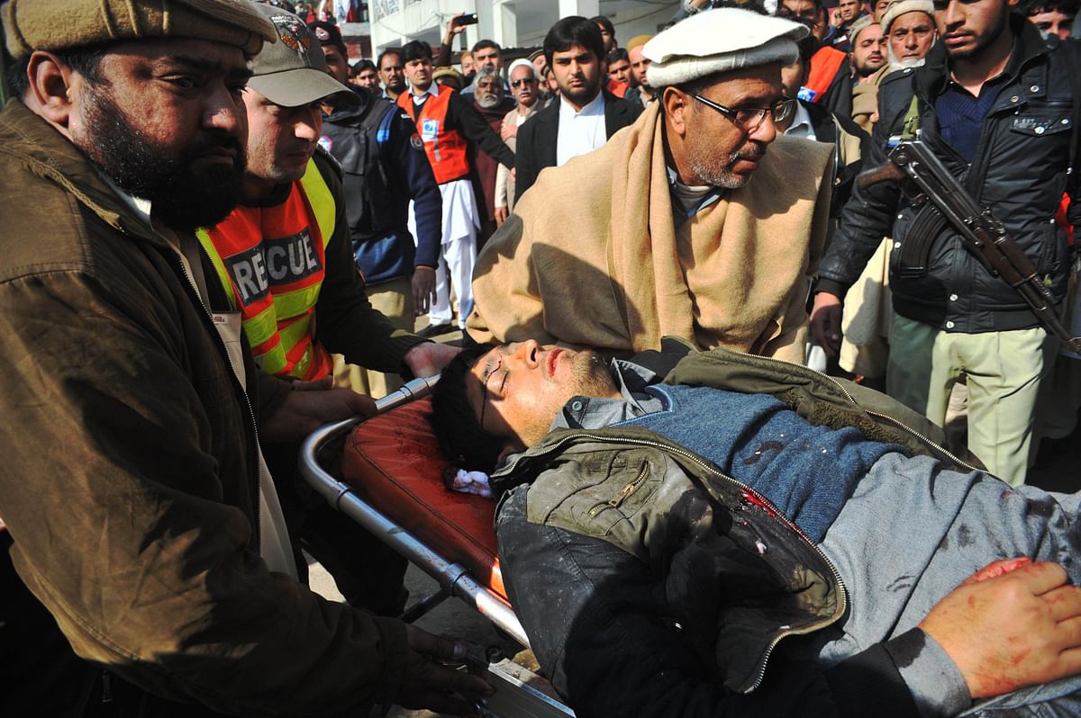 Pakistani rescuers shift an injured man to a hospital following an attack by gunmen in the Bacha Khan university in Charsadda, about 50 kilometres from Peshawar, Pakistan. Photo:AFP