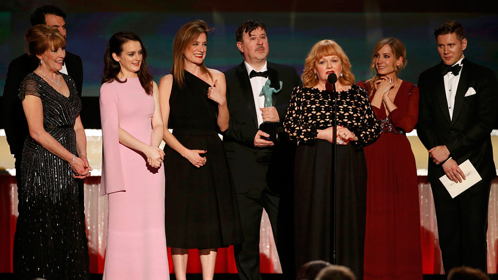 Actress Lesley Nicol (at microphone) is accompanied by members of the cast of `Downton Abbey` as they accept the award for Outstanding Performance by an Ensemble in a Drama Series at the 22nd Screen Actors Guild Awards in Los Angeles, California January 30, 2016. Photo: Reuters