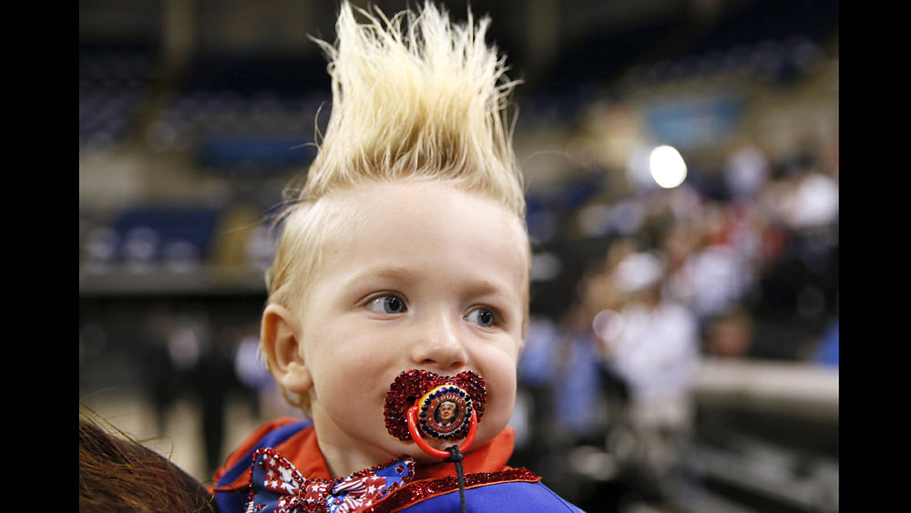 19-month-old Curtis Ray Jeffery II, of Louisiana, wears a pacifier with U.S. presidential candidate Donald Trump`s image on it before a rally in Baton Rouge, Louisiana February 11, 2016. Photo: Reuters