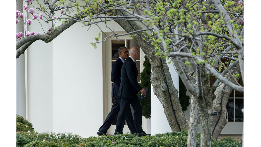 US President Barack Obama and Vice President Joe Biden walk to the Oval Office at the White House after attending the annual Friends of Ireland Luncheon at the US Capitol in Washington, DC, on 15 March 2016. Photo: AFP
