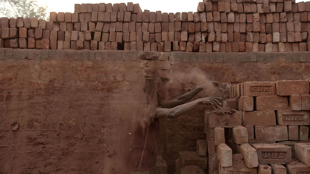 A Bangladeshi worker carries bricks at a brick factory on the outskirts of Khulna some 266kms south of Dhaka. Very few of the brick kilns in Bangladesh - approximately 7,000, according to government estimates -- have been constructed following proper design and environmental rules, according to experts. Photo: AFP
