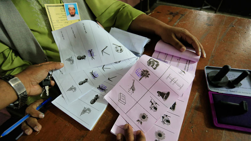 Stamped ballot papers on ruling Awami League electoral symbol `boat` and another electoral symbol of rebel AL candidate found in the hands of polling officers. The photo was taken at 3:33pm on Thursday at number 37 Konakhola Government Model Primary School centre in Keraniganj by Hasan Raja.