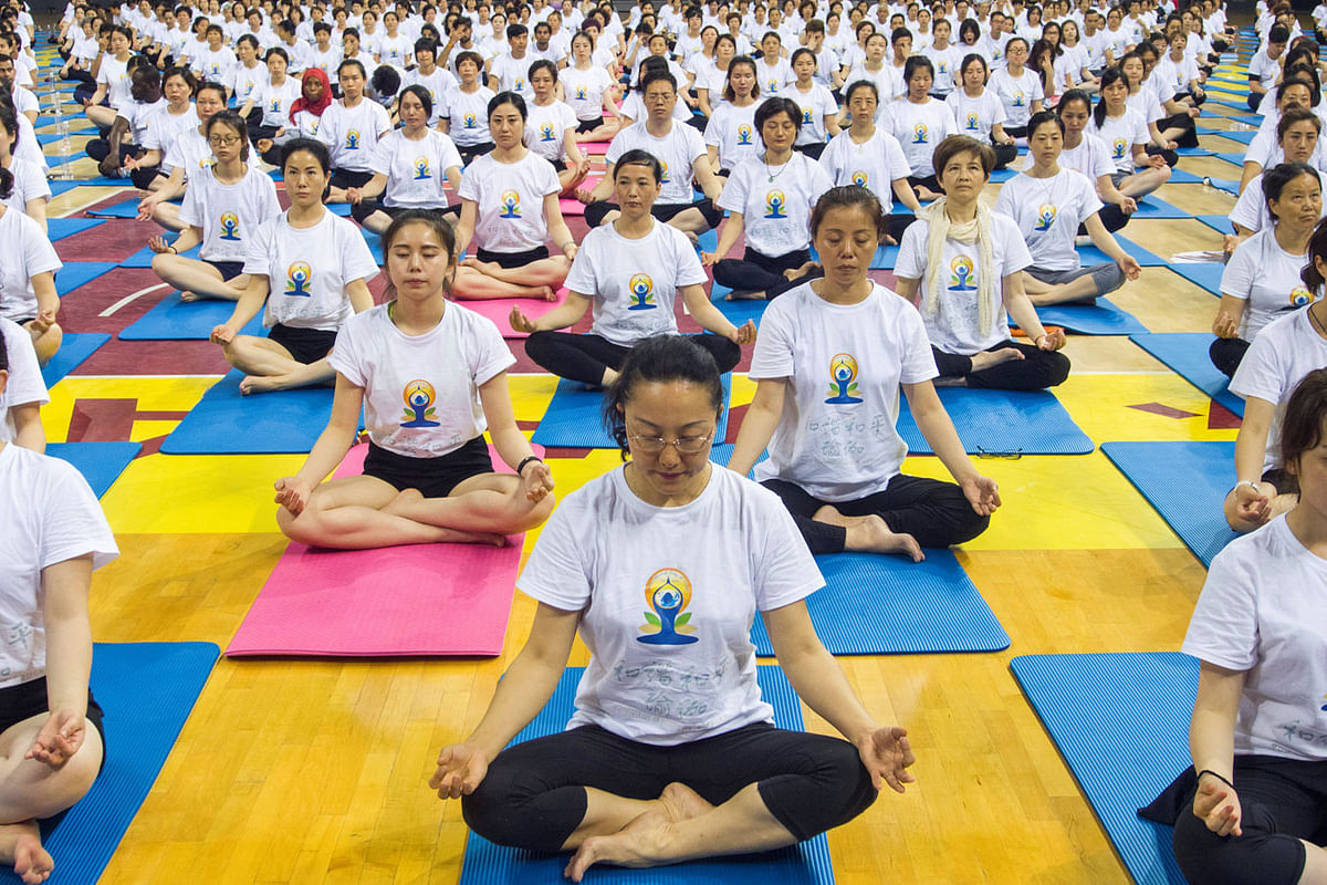 People practise yoga together ahead of World Yoga Day in Zhenjiang, Jiangsu Province, China. Photo : Reuters