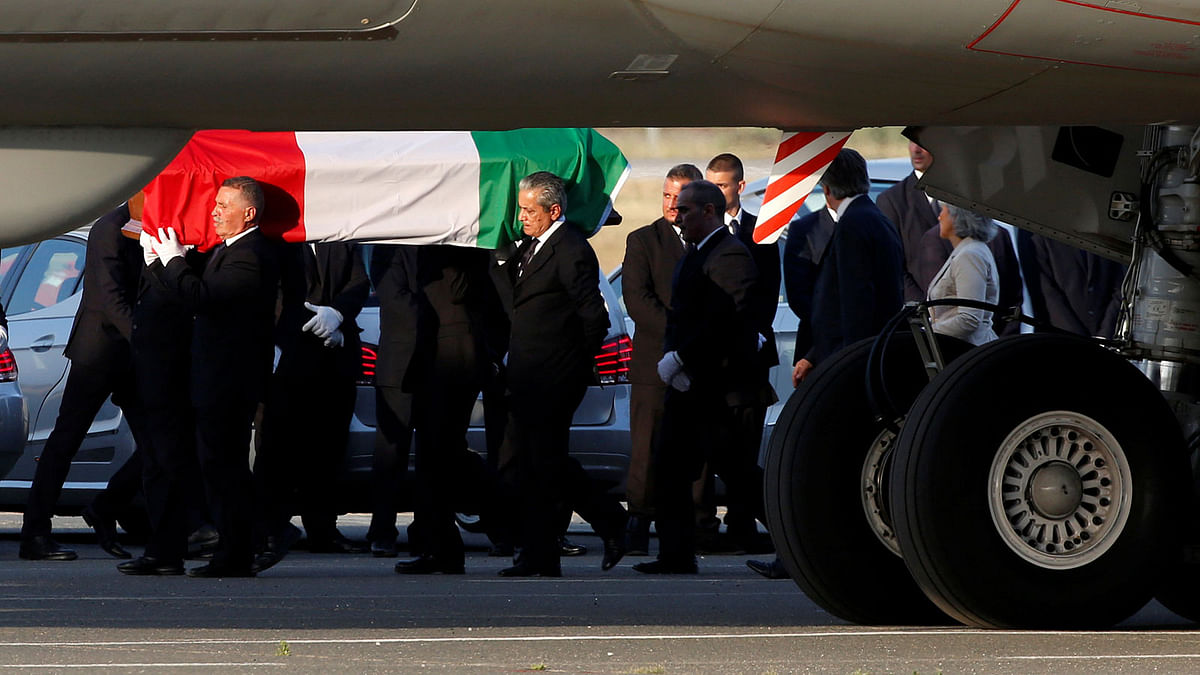A coffin containing the body of one of the nine Italians killed in the Bangladesh attack is carried by pallbearers as it is disembarked from an Italian airplane at Ciampino military airbase. Reuters