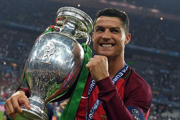 Portugal`s forward Cristiano Ronaldo smiles while posing with the trophy after Portugal won the Euro 2016 final football match between Portugal and France at the Stade de France in Saint-Denis, north of Paris, on July 10, 2016. Photo: AFP