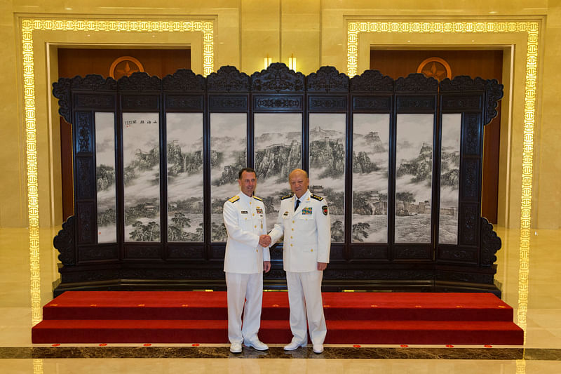 Commander of the Chinese navy, Admiral Wu Shengli shakes hands with US Chief of Naval Operations Admiral John Richardson during a welcome ceremony held at the Chinese Navy Headquarters in Beijing, China on Monday. Photo : Reuters