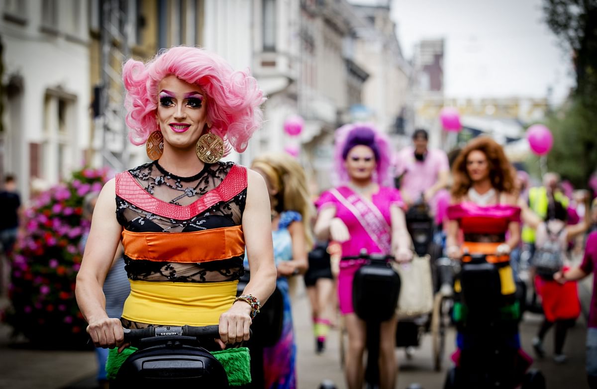 Visitors wearing fancy dresses and wigs attend the 'Pink Monday', the biggest funfair in Tilburg, on 25 July 2016. The 'Pink Monday' is a special day for the LGBT (lesbian, gay, bisexual, and transgender) community. Photo: AFP