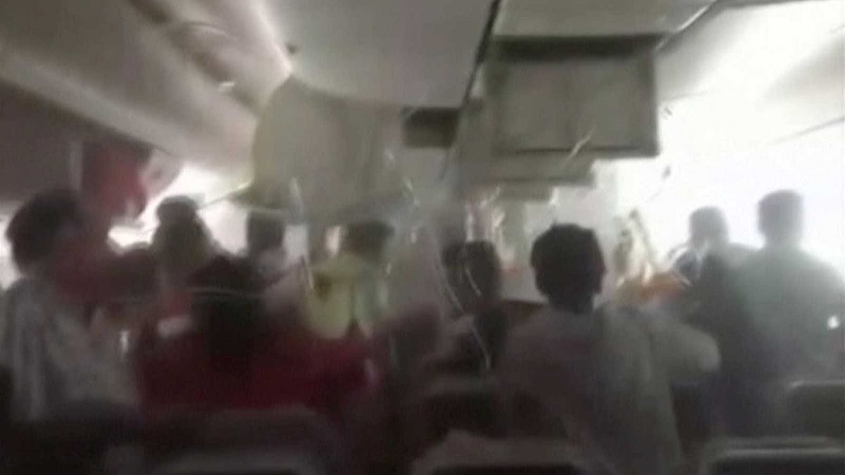 A still image from video shows passengers in an Emirates Airline airplane trying to access oxygen masks, after the plane crash-landed and seconds before the fuselage was engulfed in a ball of flame, in Dubai International Airport, United Arab Emirates August 3, 2016. Photo: Reuters