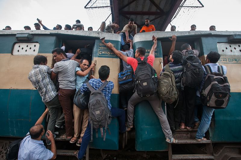 Bangladeshi Muslims scramble to reach the roof of an overcrowded train as they try to get home to their respective villages to be with their families ahead of the Muslim festival of Eid-al-Adha in Dhaka on September 8, 2016. AFP