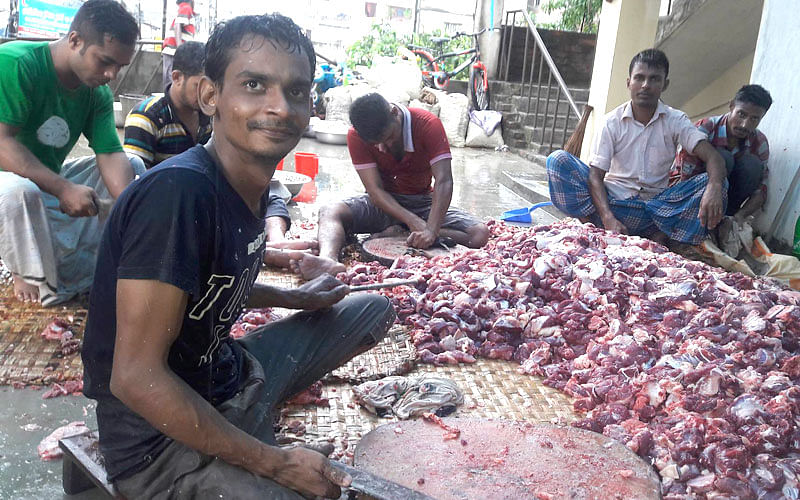 Munna Koshai with his five-man team busy chopping meat on Eid day, Tuesday. Photo: Naeem Rahman
