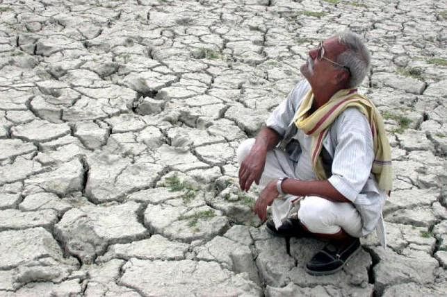 An Indian farmer looks toward the sky from his dried-up field at Phaphamau, June 6, 2003. AFP file photo