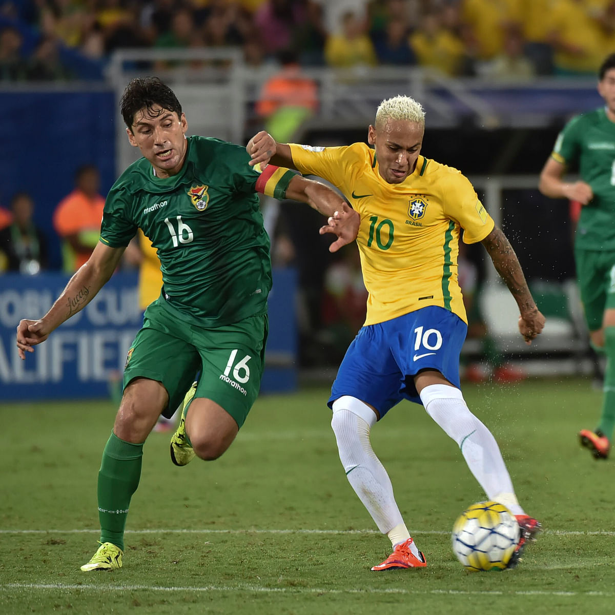 Brazil’s Neymar ® is marked by Bolivia’s Ronald Raldes during their Russia 2018 World Cup football qualifier match in Natal, Brazil. Photo: AFP