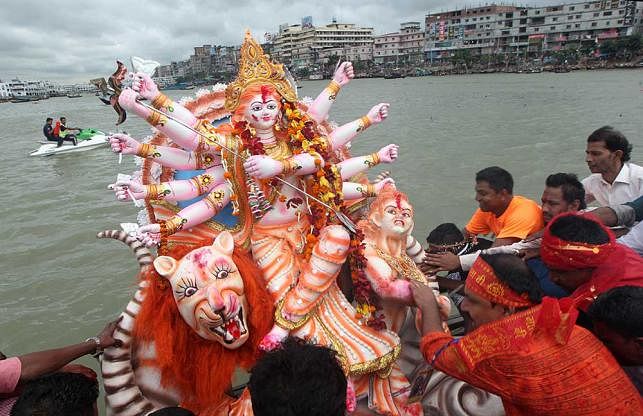 Devotees immerse idols of Goddess Durga in the Buriganga on Tuesday. Photo: Sahadat Parvez