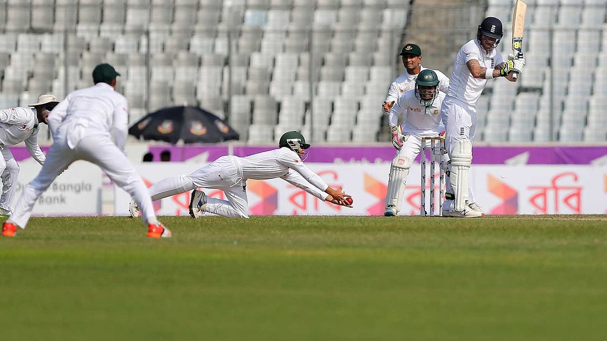 Bangladesh`s Mominul Haque dives to take a catch to dismiss England`s Ben Stokes on 29 October. Photo: Reuters