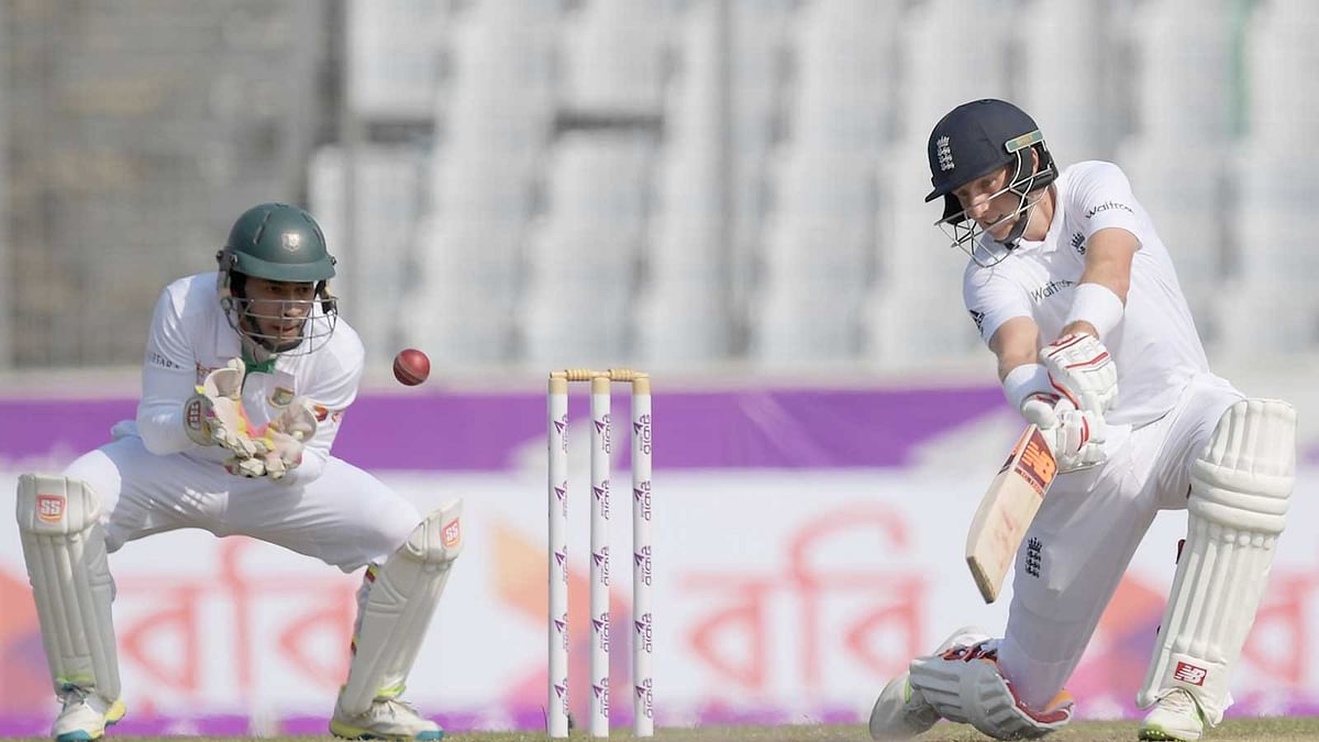 England`s Joe Root plays a shot as Bangladeshi captain Mushfiqur Rahim looks on during the second day of the second Test cricket match in Dhaka. Photo: AFP