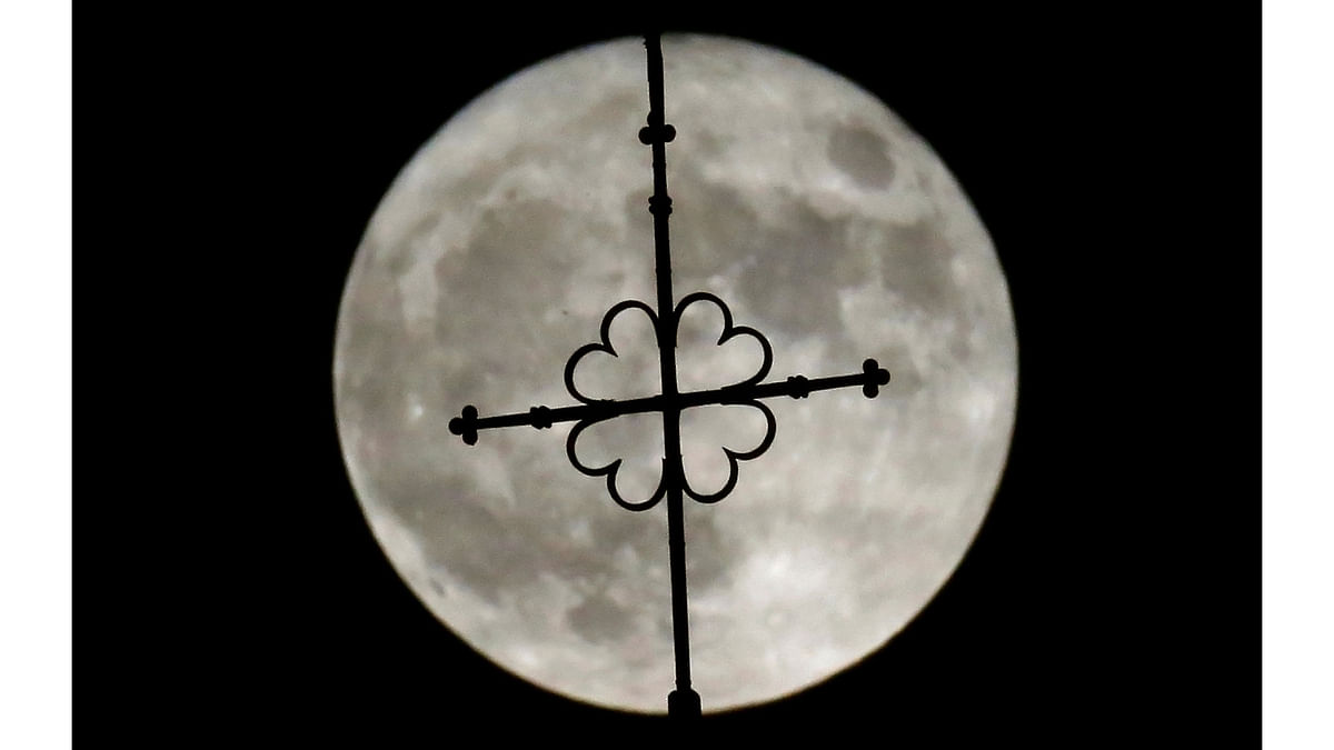 The rising supermoon is seen over the church of Saint-Hilaire in the village of Saint-Fiacre-sur-Maine near Nantes. Reuters