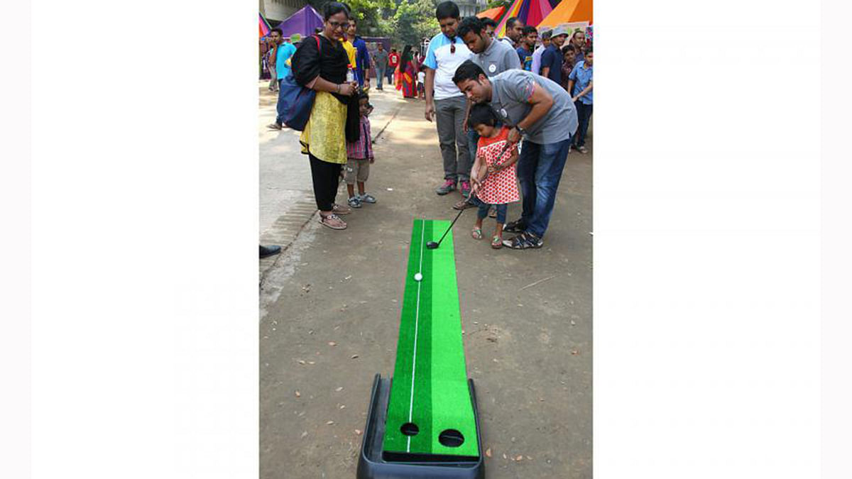 Participants play mini golf outside the Sports stall. Photo: Prothom Alo