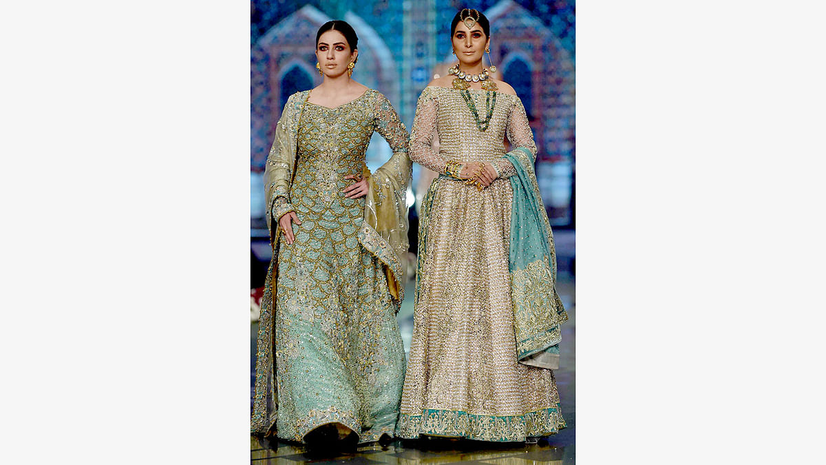 Models present creations by Pakistani fashion designer Faiza Saqlain on the final day of the Fashion Bridal Couture Week in Lahore on November 27, 2016.  Photo: AFP