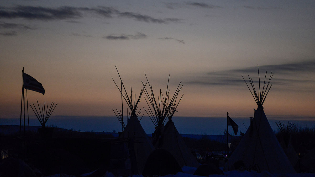 The tops of tipis are seen in Oceti Sakowin camp at sunset during a protest against plans to pass the Dakota Access pipeline near the Standing Rock Indian Reservation, near Cannon Ball, North Dakota, U.S. December 2, 2016. Photo: Reuters