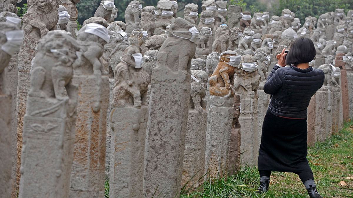 Stone pillars with masks placed on them by students of a university, as a pollution-themed art installation, are seen in the school campus in Xi`an, Shaanxi province, China, December 12, 2016. Picture taken December 12, 2016. Photo: Reuters