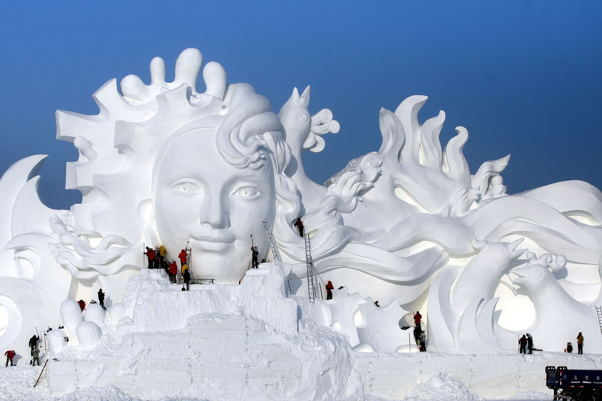 Artists work on snow sculptures at an exhibition in Harbin, Heilongjiang province, China. Photo: Reuters