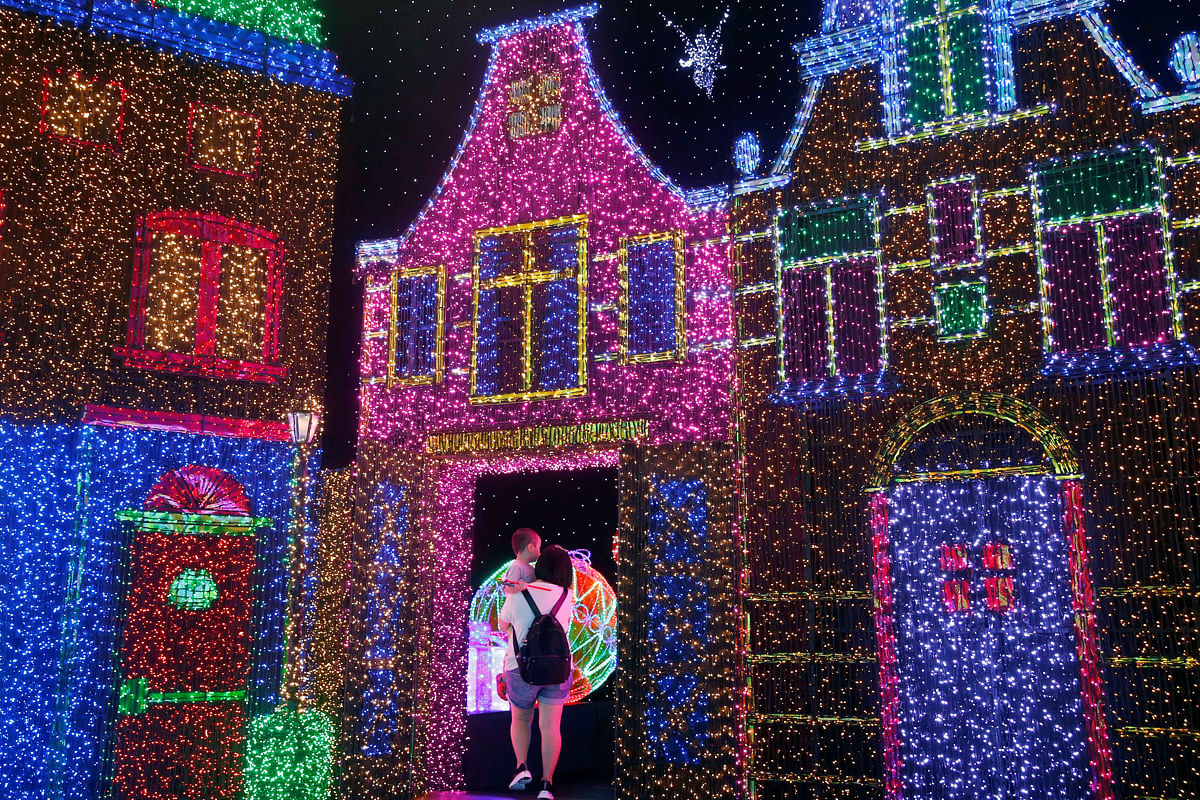 People tour a Christmas attraction featuring a display of more than 800,000 light bulbs in Universal Studios Singapore. Photo: Reuters